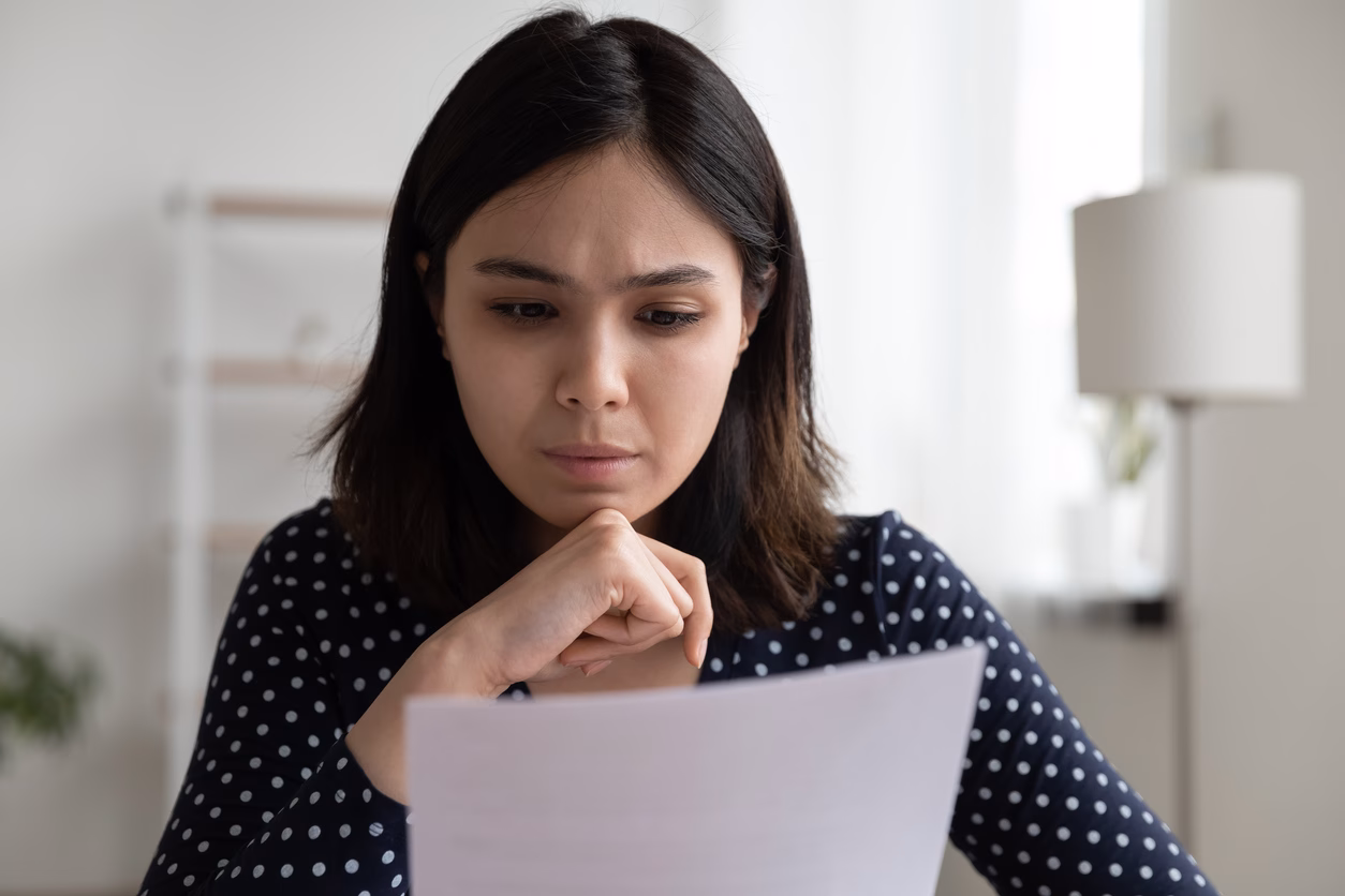 Worried young asian woman read official bank notification about debt